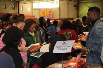 A young man sitting outdoors in Leiden, Netherlands, working on a laptop.