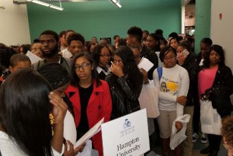 Historic neoclassical university library with columns on a sunny day.
